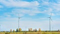 Electric wind farm, a renewable ecological energy source. Horse enclosure, pasture and wind turbines, unique view. Royalty Free Stock Photo
