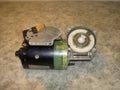 Electric wiper motor with unscrewed cover, oblique view