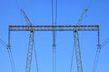 Electric wires against the blue sky. High voltage powerline tower Royalty Free Stock Photo