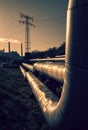 Electric wires and district heating tubes at sunrise Royalty Free Stock Photo
