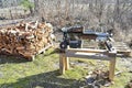 electric wood splitter standing infront of firewood Royalty Free Stock Photo
