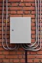 Electrical box on a brick wall. plastic cable channels Royalty Free Stock Photo