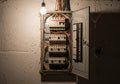 An electrical breaker panel with its door open, revealing multiple circuit breakers labeled for Royalty Free Stock Photo