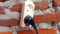 electrical cable plug attached to the red brick wall