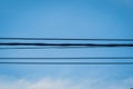 Electrical cable wire with blue cloudy sky as background Royalty Free Stock Photo