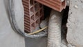Electrical wiring and conduit pipe inside brick wall construction Royalty Free Stock Photo