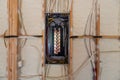 Electrical Circuit Breaker panel in new home construction, with spray foam insulation and negative space Royalty Free Stock Photo