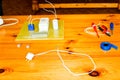 Electrical circuit with wires and spare parts, installation equipment, pliers, blue electrical tape, screwdrivers on the table