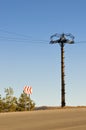 Electrical column in field under blue sky Royalty Free Stock Photo