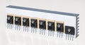 Electrical components on aluminum heat sink of switch-mode power supply on white background