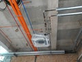 Electrical conduit, cable tray and aircond pipes as part of services above ceiling installed at the construction.