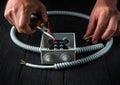 Electrical connection in the workshop of a master electrician. Close-up of hands of a master electrician during work. Installing a Royalty Free Stock Photo