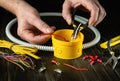 The electrical connection in the workshop of a master electrician. Close-up of the hands of an electrician during work. Cutting a