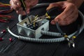 Electrical connection in the workshop of a master electrician. Close-up of hands of a master electrician during work. Installing a Royalty Free Stock Photo