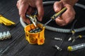 Electrical connection in the workshop of a master electrician. Close-up of hands of a master electrician during work. Installing a Royalty Free Stock Photo