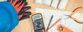 Electrical drawings, multimeter for measurement in electrical installation and accessories for engineer jobs Royalty Free Stock Photo