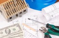 Electrical construction drawings, work tools and accessories, small house and currencies dollar, building home cost concept Royalty Free Stock Photo