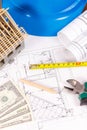 Electrical construction drawings, work tools and accessories, small house and currencies dollar, building home cost concept Royalty Free Stock Photo