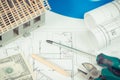 Electrical construction drawings, work tools and accessories, small house and currencies dollar Royalty Free Stock Photo