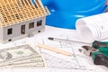 Electrical construction drawings, work tools and accessories, small toy house and currencies dollar, building home cost concept