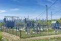 Electrical distribution transformer substation, against the background of green vegetation