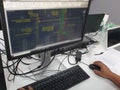 Electrical draftsman working on the computer monitor with typing keyboard and mouse