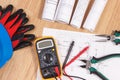 Electrical drawings, multimeter for measurement in electrical installation and accessories for engineer jobs Royalty Free Stock Photo