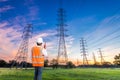 Electrical engineer with high voltage electricity pylon Royalty Free Stock Photo