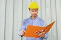 Electrical Engineer holding files while wearing a personal protective equipment safety helmet Royalty Free Stock Photo