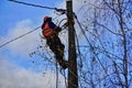 Electrical engineer holding safety helmet with electricians working on electric power pole with bucket hydraulic lifting