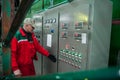 Electrical engineer next to the dashboard controls