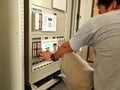 Electrical engineer rechecks protection relay setting before secondary current injection test. Royalty Free Stock Photo