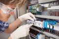 Electrical engineer repairing fusebox