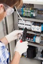 Electrical engineer repairing fusebox Royalty Free Stock Photo