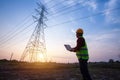 Electrical engineer standing and watching at the electric power station to view the planning work by producing electricity at high Royalty Free Stock Photo