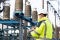 Electrical engineer studying reading on tablet. Electrical worker engineer a working with digital tablet, power near Royalty Free Stock Photo