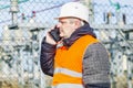 Electrical engineer talking on cell phone at power station Royalty Free Stock Photo