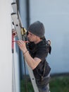 an electrical engineer of the team installs the electrical cables for the autonomous photovoltaic solar panel system. It is