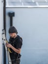 an electrical engineer of the team installs the electrical cables for the autonomous photovoltaic solar panel system. It is