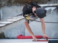 an electrical engineer of the team installs the electrical cables for the autonomous photovoltaic solar panel system. It is