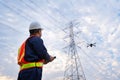 An electrical engineer or technician location use drone to fly inspections at the electric power station to view the planning work