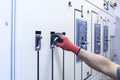 Electrical engineer tests the operation of the electric control cabinet on a regular basis for maintenance. Royalty Free Stock Photo