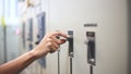 Electrical engineer tests the operation of the electric control cabinet on a regular basis for maintenance. Royalty Free Stock Photo