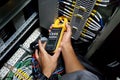 The electrical engineer used current clamp meter measuring current at the terminal Royalty Free Stock Photo