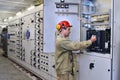 Electrical engineer uses equipment of the switchboard.