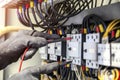 Electrical engineer using measuring equipment to checking electric current voltage at circuit breaker and cable wiring system for