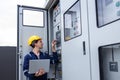 Electrical engineer working in control room. Electrical engineer man checking Power Distribution Cabinet in the control room Royalty Free Stock Photo