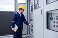 Electrical engineer working in control room. Electrical engineer man checking Power Distribution Cabinet in the control room Royalty Free Stock Photo