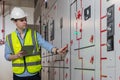 Electrical engineer working in control room. Electrical engineer man checking Power Distribution Cabinet in the control room Royalty Free Stock Photo