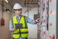 Electrical engineer working in control room. Electrical engineer man checking Power Distribution Cabinet in the control room Royalty Free Stock Photo